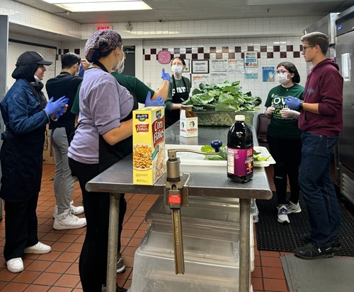 Alternative Spartan Break volunteers from the November 16-17, 2024 Breaking Barriers, Building Futures experience prepare to work in a kitchen.