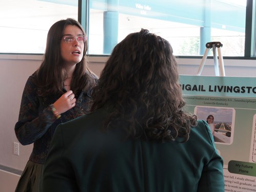 Scholar Abigail Livingston presenting her poster about her engagement with Allen Neighborhood Center and CESP leadership at the 2026 CESP showcase.