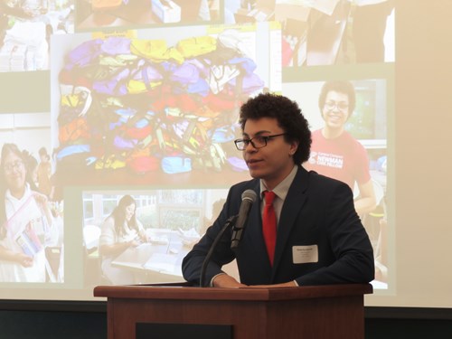 Scholar and Newman Civic Fellow giving remarks at the CESP Showcase about the cohort's project creating resource kits for the Tenant Resource Center to distribute to unhoused neighbors.