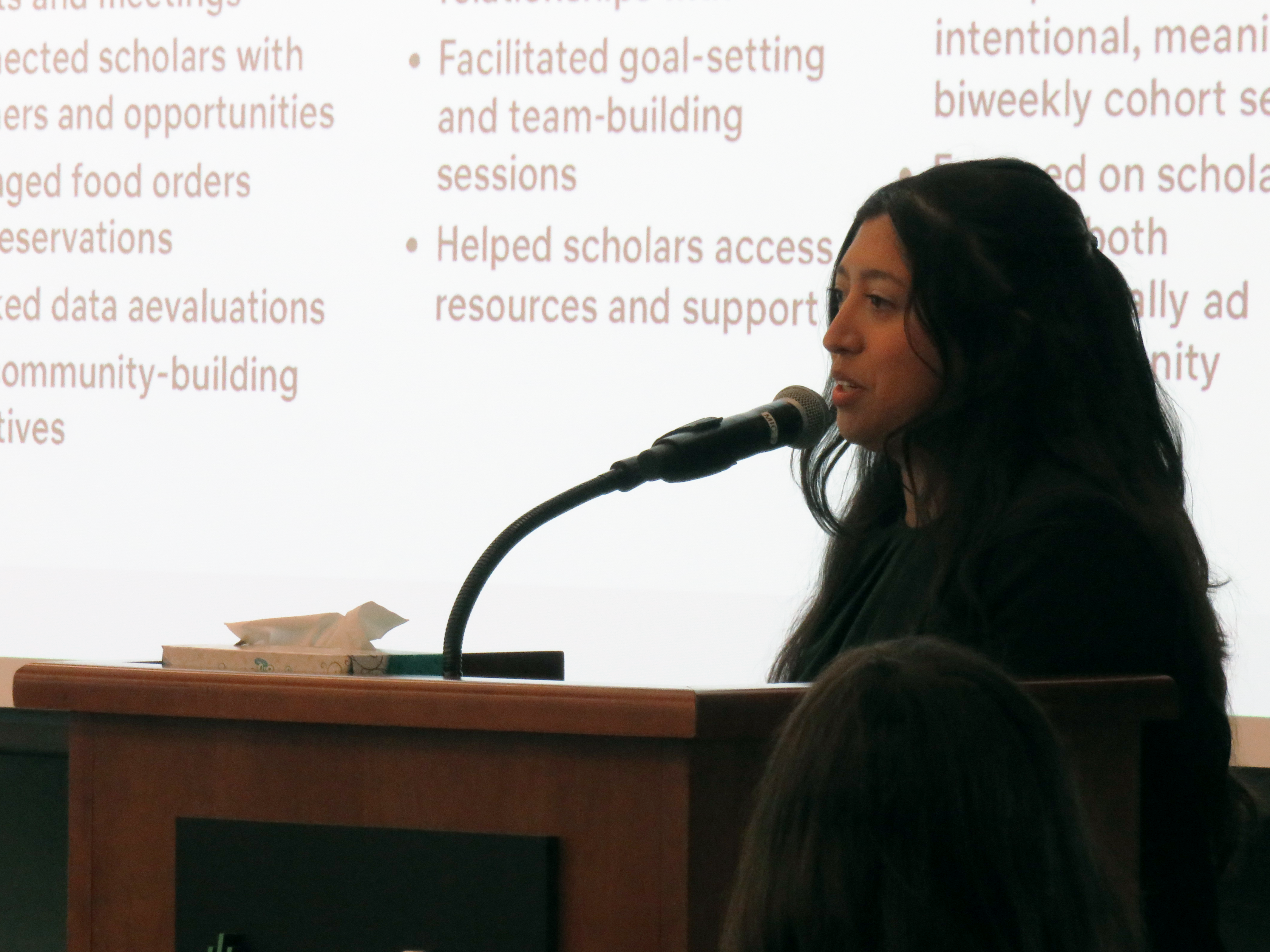 Graduate Coordinator Vivian Morales addresses showcase attendees during a presentation about her position.