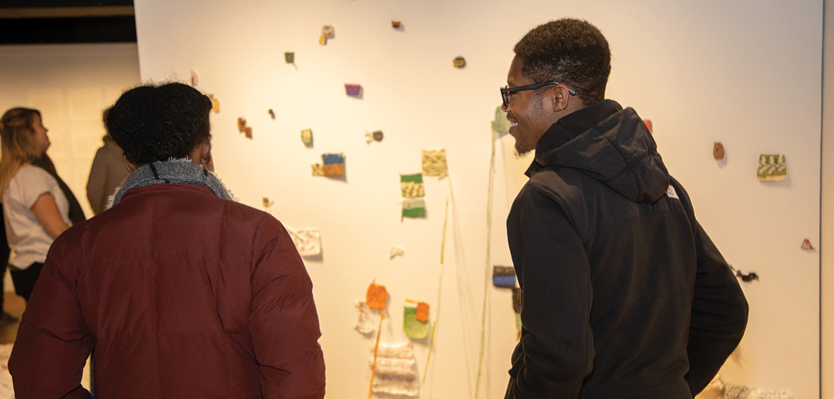 Students view the CARE, Not Convenience Exhibition