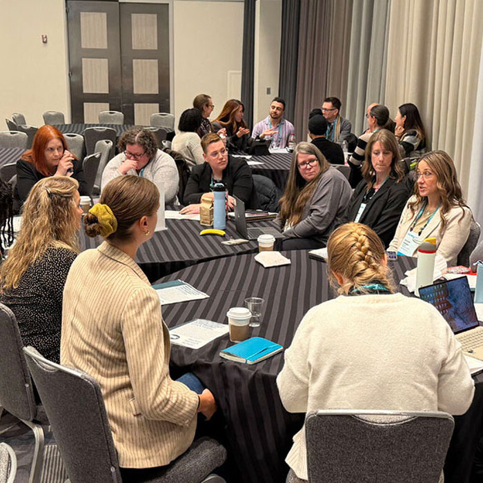 Academic Program Team members Stephanie Brewer and Michelle Snitgen (back of front table) speak at their roundtable with assistant director Tina Houghton (front of table, second from left) at the Compact26 National Conference on March 16-18, 2026 in Chicago. This roundtable, titled Mapping Community-Engaged Learning to Career Readiness: Advancing Student Learning Assessment, focused on the team’s pilot learning outcomes for community-engaged student programs.