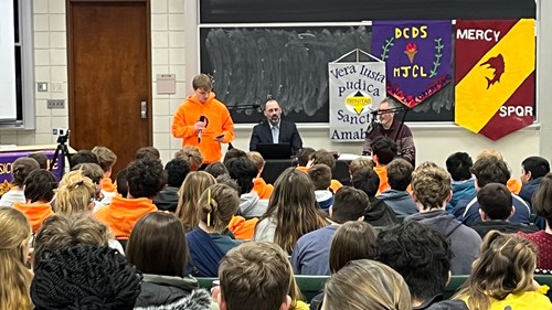 A Michigan Junior Classical League student addresses their peers during a plenary session in Wells Hall.