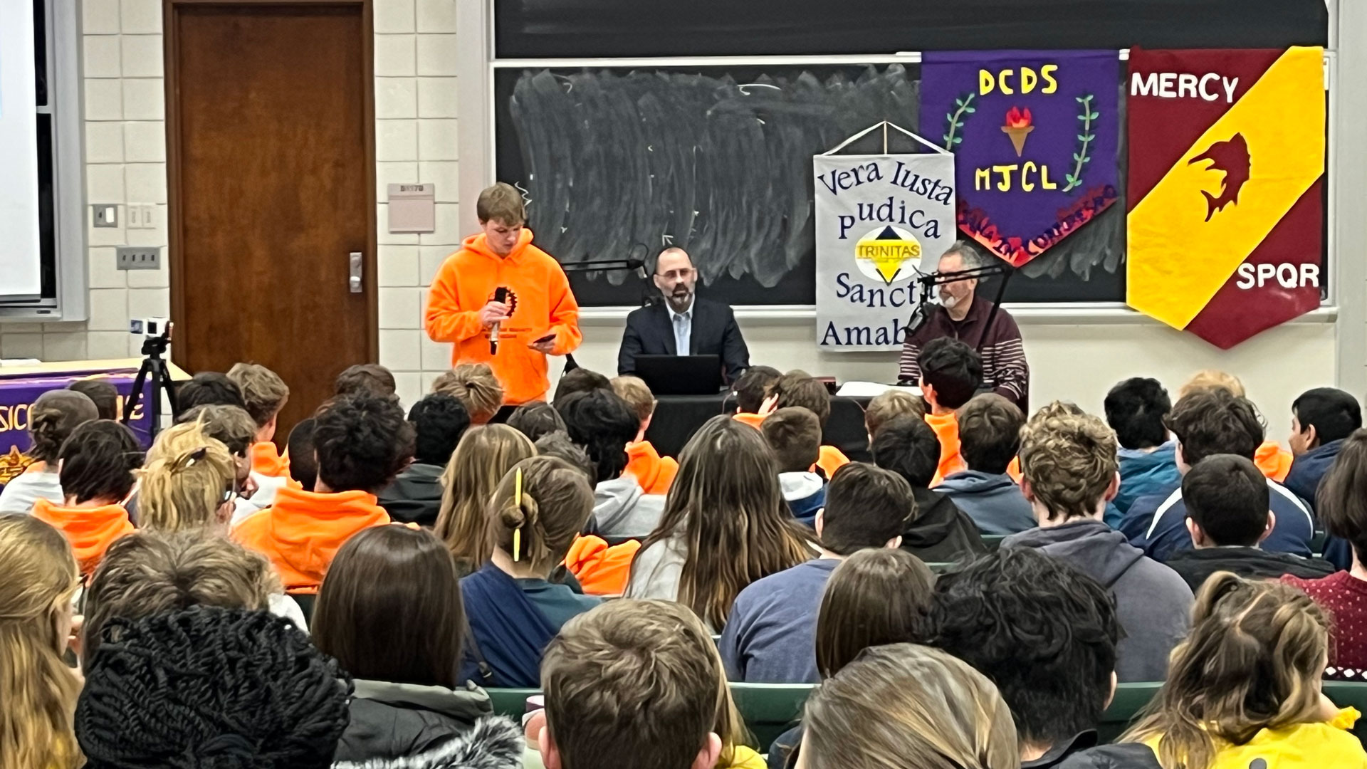 A Michigan Junior Classical League student addresses their peers during a plenary session in Wells Hall.