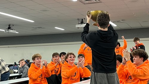 The Latin Honor Society certamen team is awarded with a trophy for winning their quiz competition.
