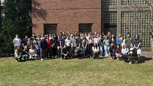 A class photo of Data Science capstone students in a courtyard next to the College of Engineering