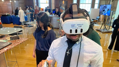Student Kendall Lesure uses a virtual reality headset from Henry Ford Health to explore current medical imaging technology.
