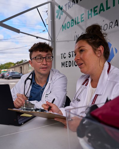 A rural community health student and local doctor provide care at a mobile health clinic in Traverse City, Michigan.