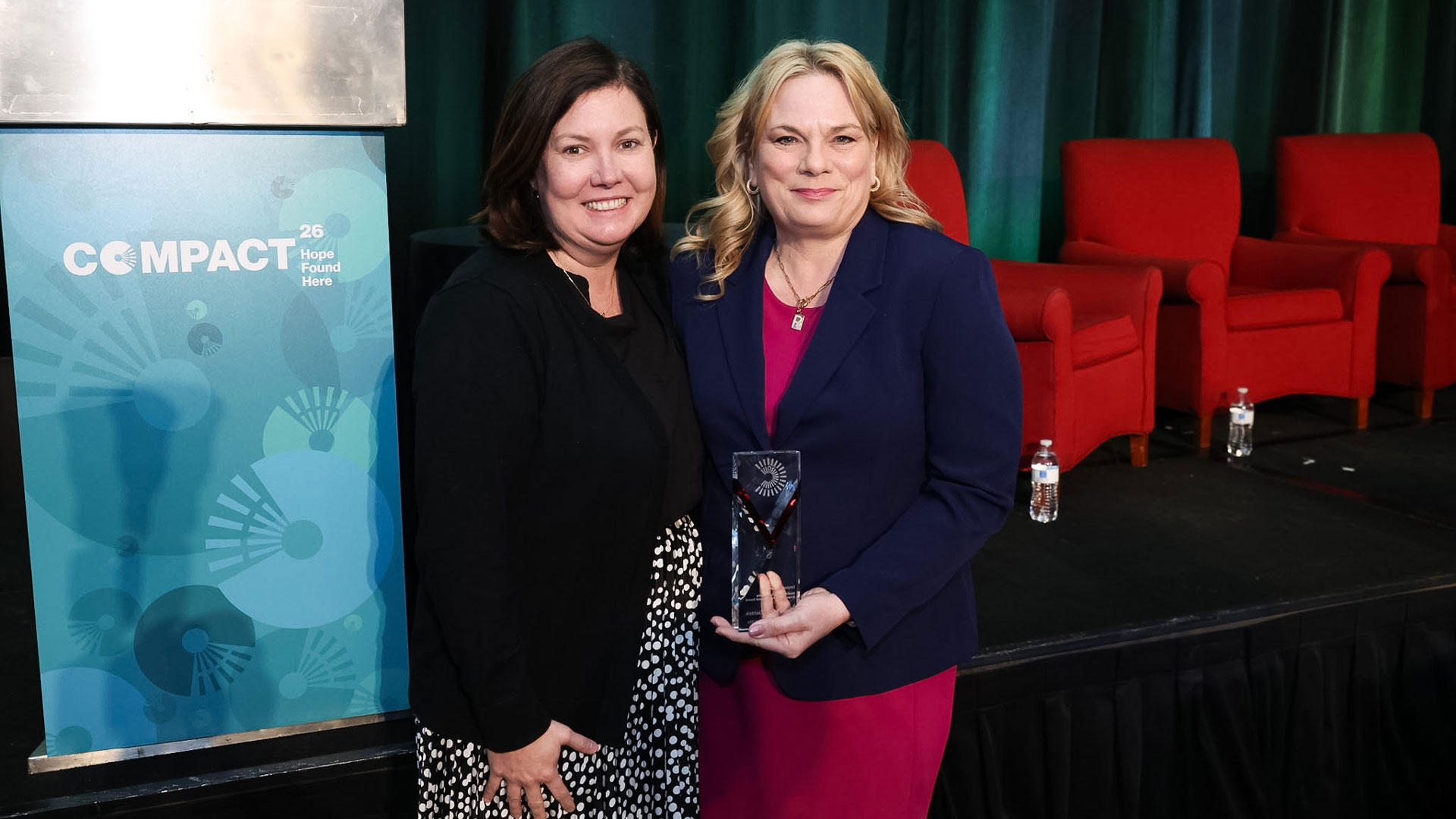 Campus Compact president Bobbie Laur (left) and Renee Miller Zientek, holding the Nadinne Cruz Community Engagement Professional Award.