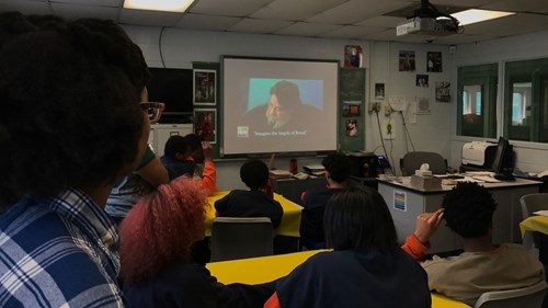 Participants at ICYC and MSU students watch a recorded poetry reading in preparation for a poetry workshop.